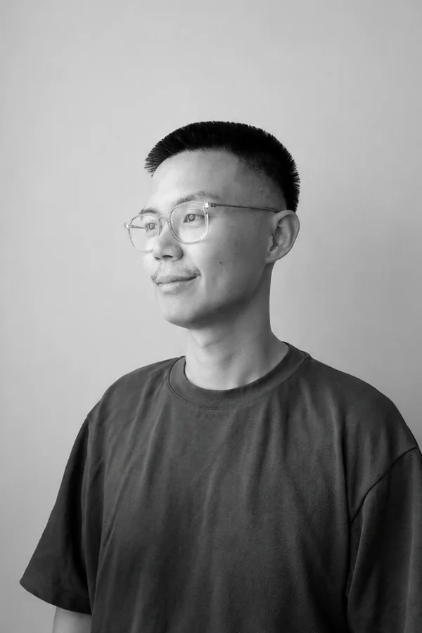 Marcus in a black and white portrait, looking off to one side